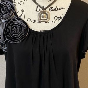 Black shirt with rose detail on right shoulder